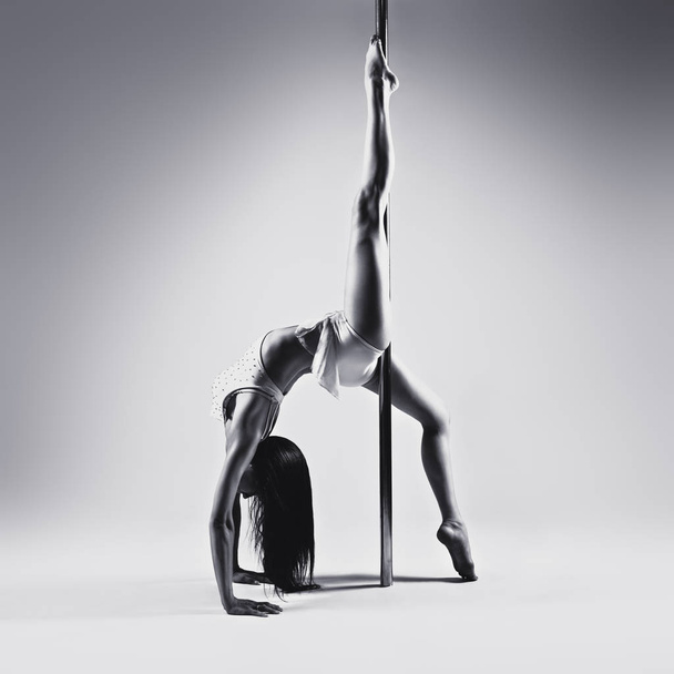 Young pole dancing woman - Fotó, kép
