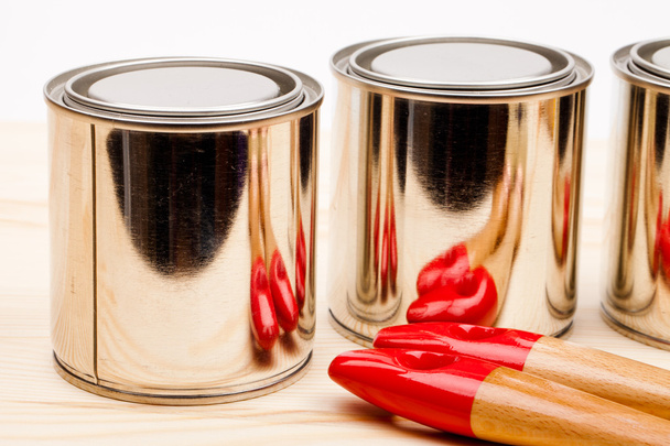 Cans of paint with paintbrushes isolated on white - 写真・画像