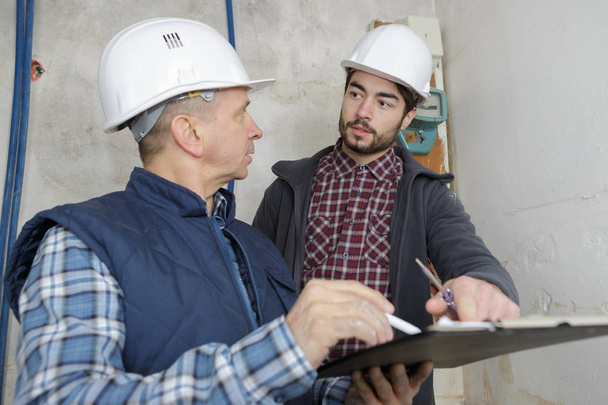 builder and inspector looking at new property - Photo, image