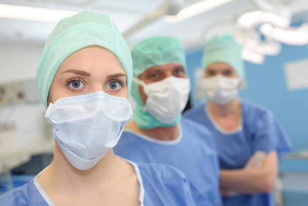 Row in medical staff wearing masks - Fotó, kép