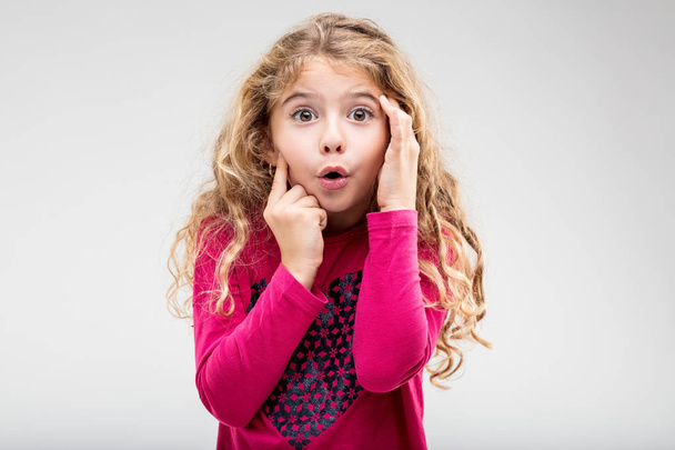 Cute little girl with a look of astonishment - Photo, Image