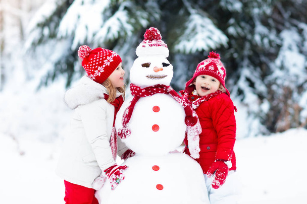 Kids building snowman. Children in snow. Winter fun. - Photo, Image