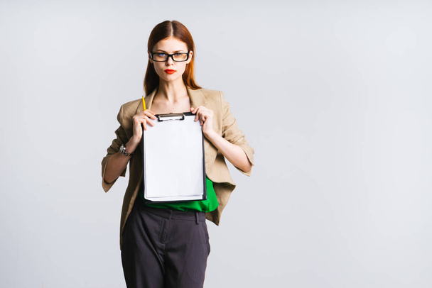 girl secretary in glasses holds a file in both hands - Foto, Bild
