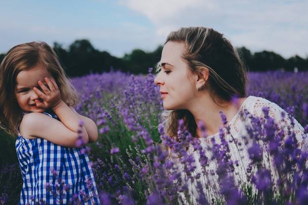 Mother and sad toddler in a lavender. - Φωτογραφία, εικόνα