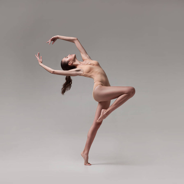 young beautiful ballet dancer in beige swimsuit - Фото, изображение
