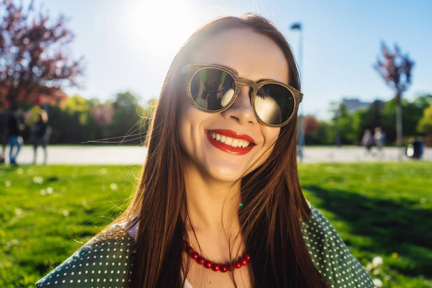 Fashion woman in glasses outside.Summer glamour smiling girl - 写真・画像