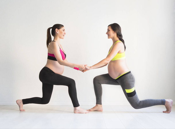 Two young pregnant women doing fitness exercises - Photo, Image