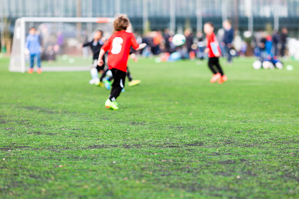 Blur of young boys playing soccer match - 写真・画像