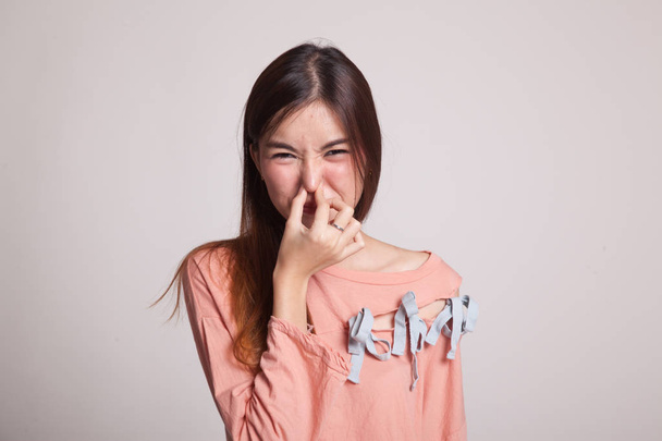 Young Asian woman  holding her nose because of a bad smell. - 写真・画像