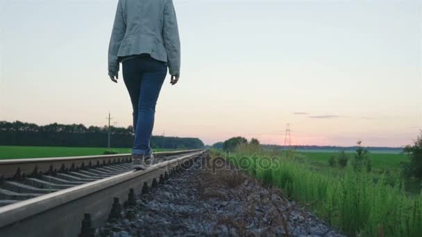 Κοπέλα βαδίζει στην τροχιά σιδηροδρόμων - Πλάνα, βίντεο