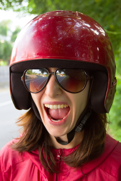 Young scared woman in motorcycle helmet - Φωτογραφία, εικόνα