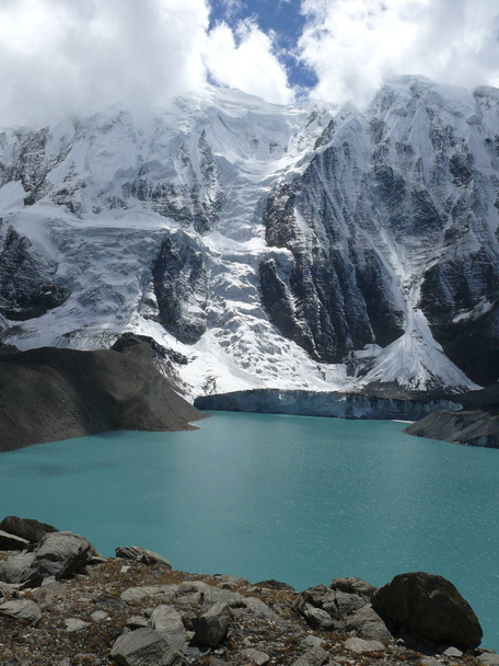 Mountain Ice wall falling to the Tilicho lake - Photo, Image