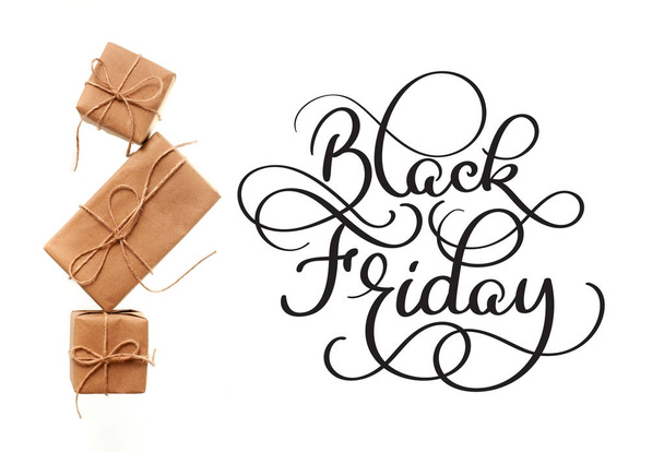 Black Friday calligraphy text on white background and gifts. Hand written - Foto, Imagem