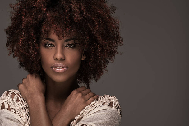 Beautiful woman with afro hairstyle posing. - 写真・画像