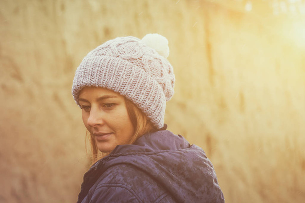woman in a knitted  cap  walking - Fotó, kép