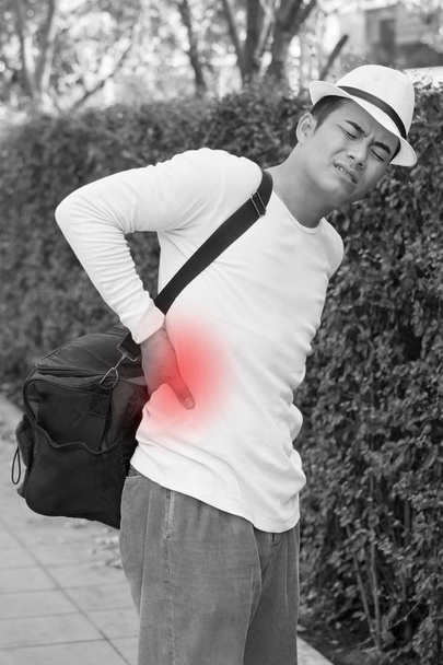 back pain man carrying heavy bag - Photo, Image