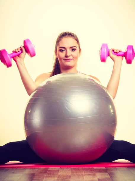 Girl warming up with ball and dumb bell weights. - Fotoğraf, Görsel
