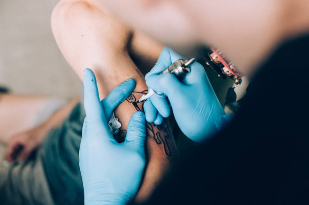 close up of professional artist tattooing - 写真・画像