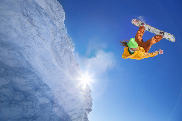 Snowboarder jumping against blue sky - Photo, Image