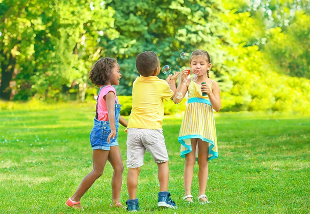 Cute little children playing outdoors - Фото, изображение