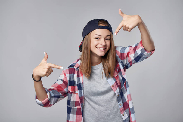 Smiling teen girl pointing at herself - Foto, afbeelding
