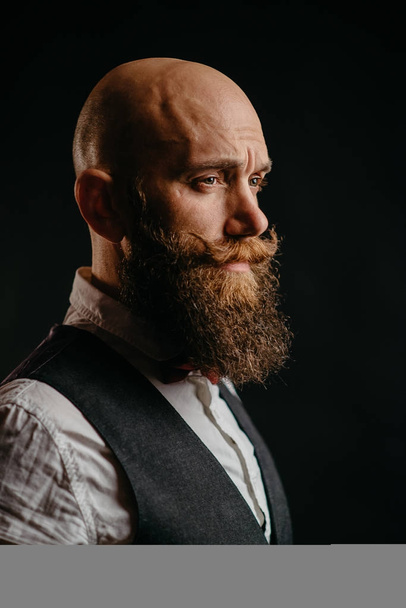 portrait of a stylish bearded man on a black background - Fotografie, Obrázek