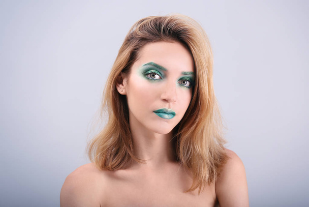 Young woman with bright green makeup  - Fotó, kép