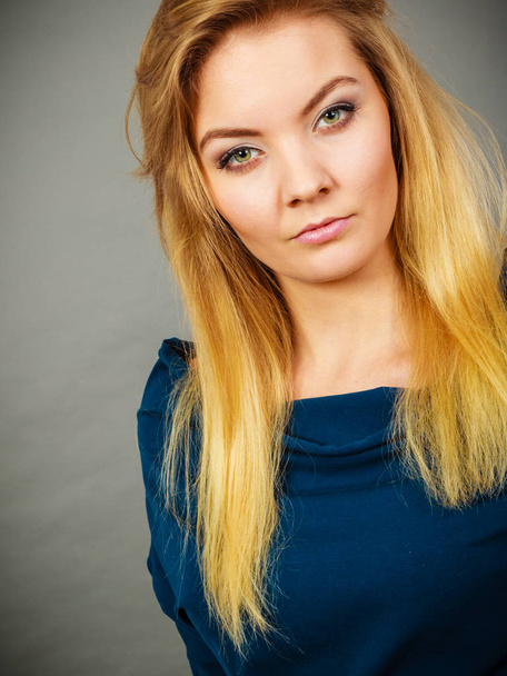 Portrait blonde young woman having serious face expression - Foto, imagen