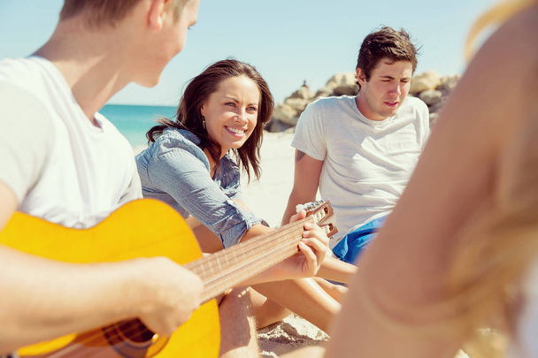 Beautiful young people with guitar on beach - Φωτογραφία, εικόνα