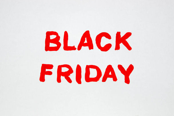 The inscription on a white sheet of paper. Black Friday. A 50% discount. Sale. The inscription painted - Foto, afbeelding