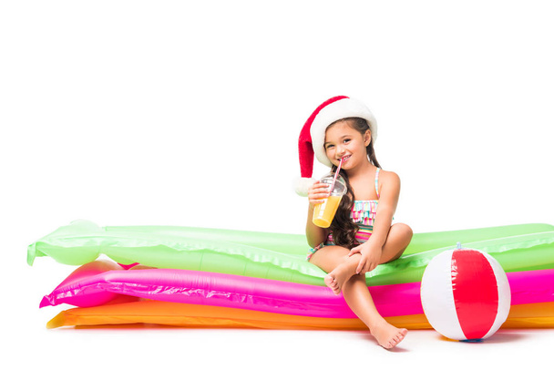 kid in santa hat with orange juice   - Foto, Imagem