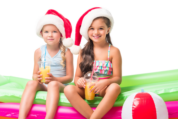 τα παιδιά στο santa καπέλα με χυμό πορτοκαλιού   - Φωτογραφία, εικόνα