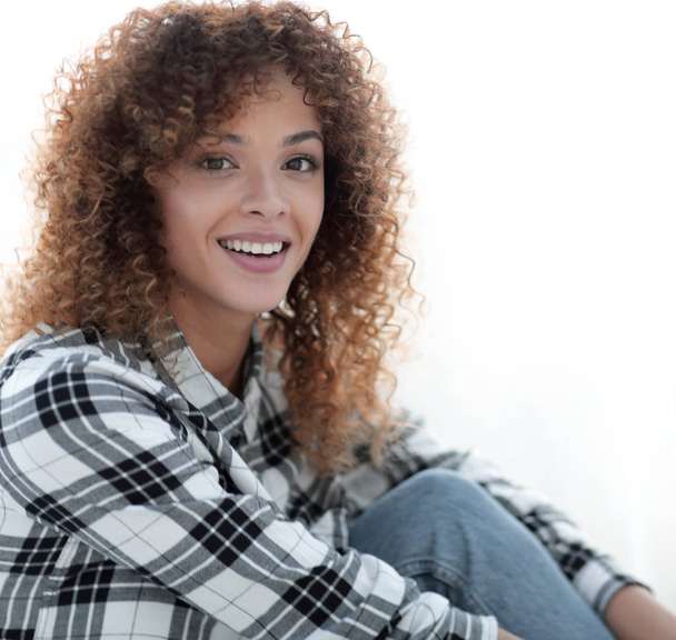 young woman with curly hair in a plaid shirt - Фото, изображение