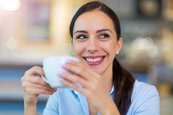 Woman drinking coffee in cafe  - Valokuva, kuva