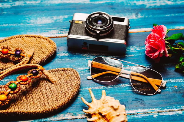 Flat lay of summer fashion camera, sunglasses and other girl accessories on white wooden background - Fotografie, Obrázek