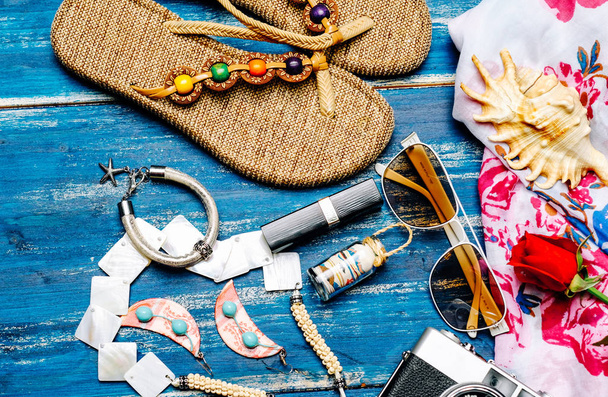 Flat lay of summer fashion camera, sunglasses and other girl accessories on white wooden background - 写真・画像