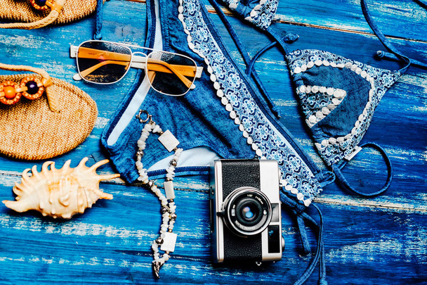 Flat lay of summer fashion camera, sunglasses and other girl accessories on white wooden background - Фото, зображення