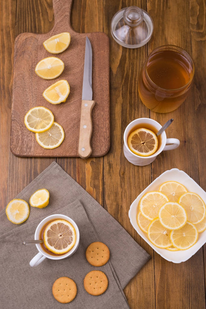 Composition with lemon tea on a wooden table - Фото, изображение