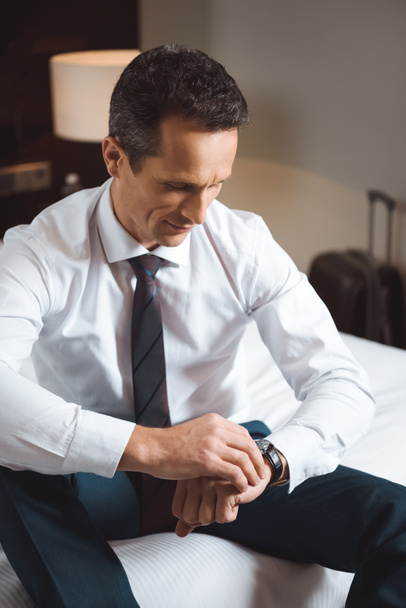 Businessman looking at watch - Photo, Image
