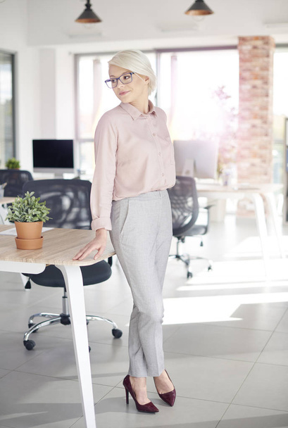 Business person leaning on office desk  - Photo, Image