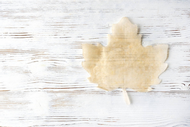 Light Wooden background. Maple leaf paper for baking. Dessert plate. The restaurant's menu. - Photo, Image