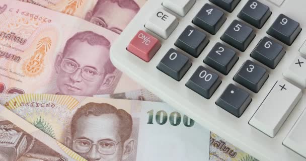 4k rotating Baht money & calculator. - Video