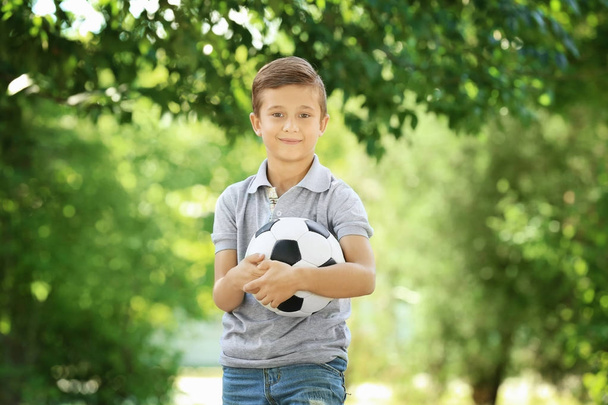 Cute boy with soccer ball in park - Fotoğraf, Görsel
