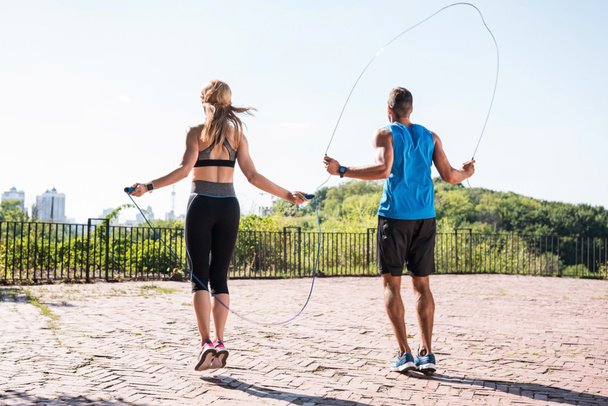 jumping on skipping ropes - Foto, afbeelding