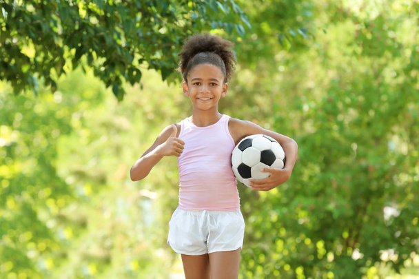 Cute African American girl with ball in park - Φωτογραφία, εικόνα