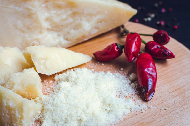 Grated Parmesan cheese on wooden board - Фото, зображення