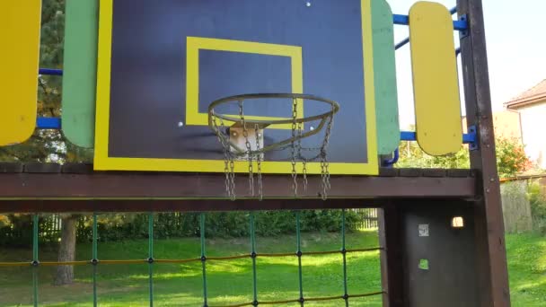 Ball going through basket hoop in school basketball court. Basketball falls through the chain net. - Footage, Video