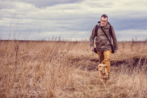Hiker and small yellow dog - 写真・画像