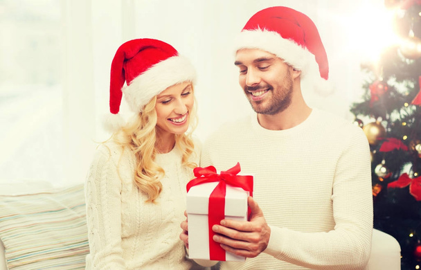 happy couple at home with christmas gift box - Photo, image