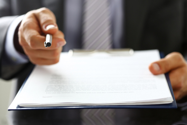 Male arm in suit offer contract form on clipboard pad - Photo, Image